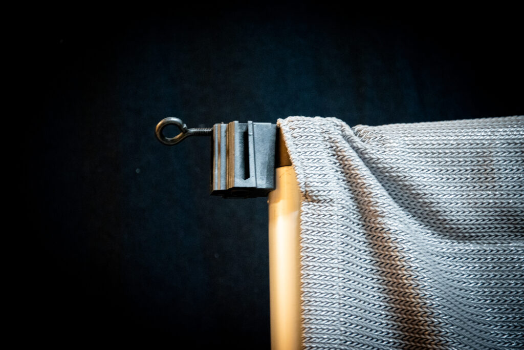 Shoulder Block mounted to Upright covered by silver curtain